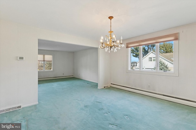 spare room with visible vents, baseboard heating, a notable chandelier, and carpet