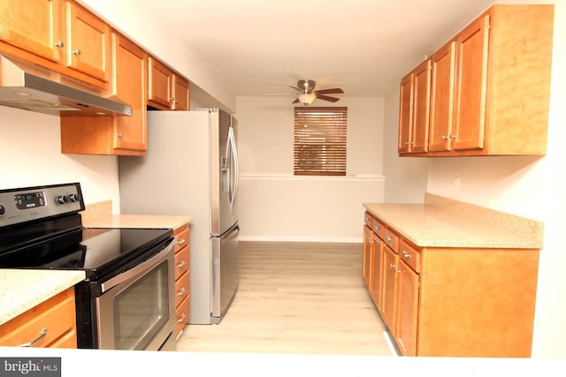 kitchen featuring under cabinet range hood, electric range, brown cabinets, and a ceiling fan