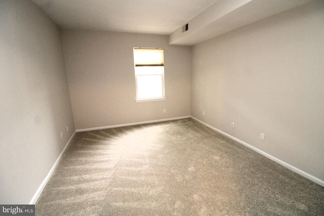 empty room featuring baseboards and visible vents