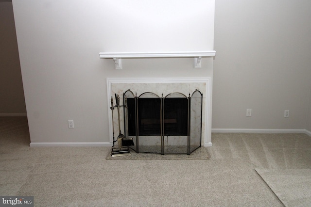 room details featuring a premium fireplace, baseboards, and carpet floors