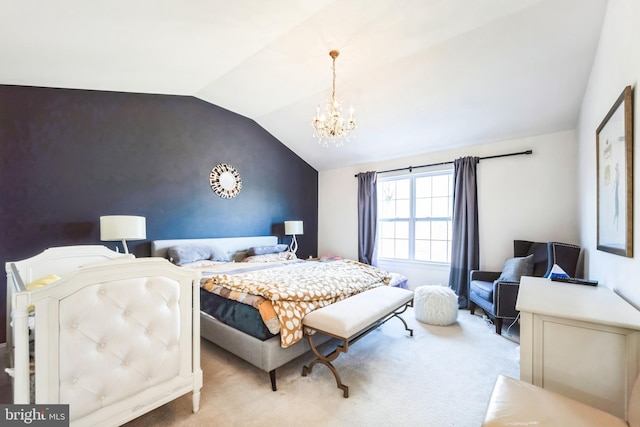 carpeted bedroom featuring a notable chandelier, an accent wall, and vaulted ceiling