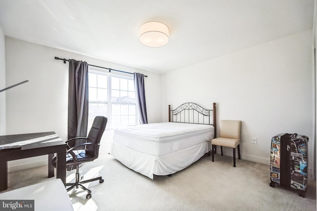 carpeted bedroom with baseboards