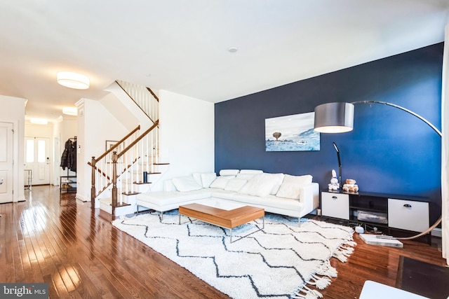 living area featuring hardwood / wood-style flooring and stairway