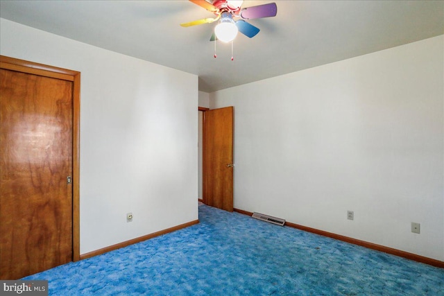 unfurnished bedroom with visible vents, baseboards, carpet floors, and ceiling fan