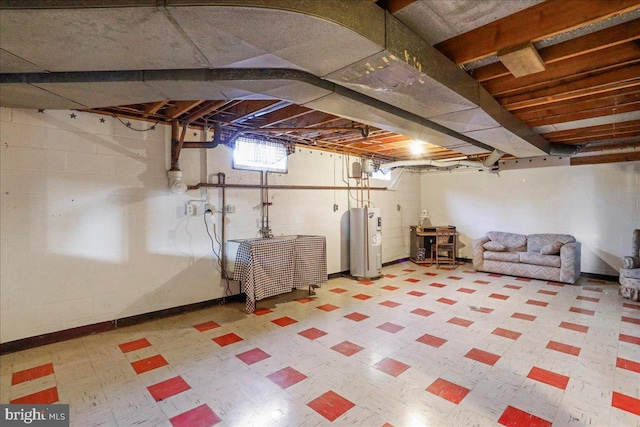 basement featuring tile patterned floors and electric water heater