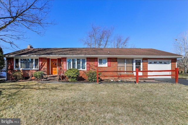 ranch-style house with brick siding, a front yard, aphalt driveway, and a garage