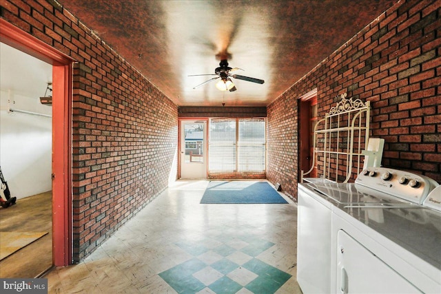 unfurnished sunroom featuring separate washer and dryer and a ceiling fan