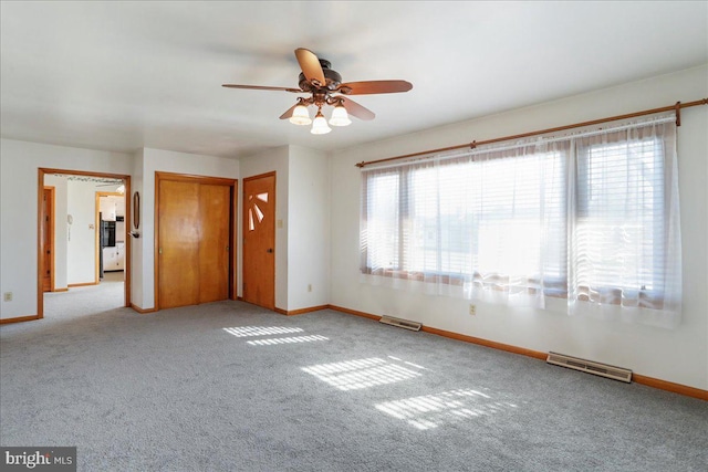 empty room featuring baseboards, visible vents, and carpet floors