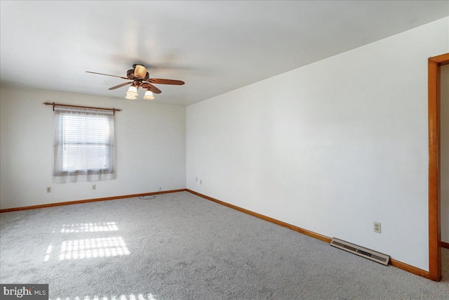 spare room with visible vents, baseboards, carpet, and a ceiling fan