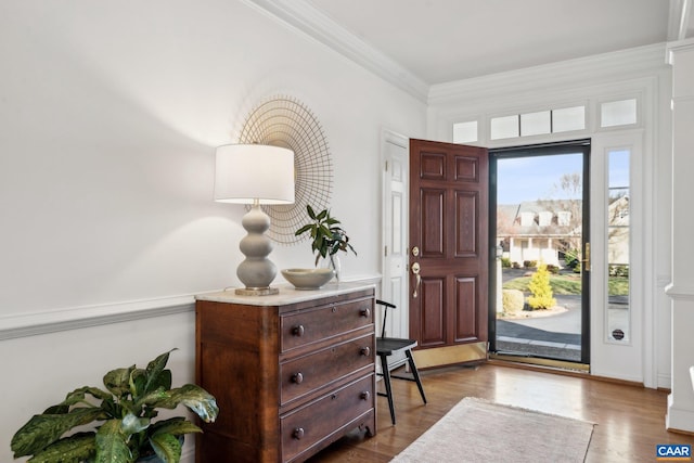 entryway featuring dark wood finished floors and ornamental molding