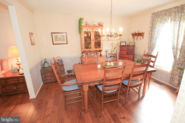 dining room featuring plenty of natural light, wainscoting, visible vents, and wood-type flooring