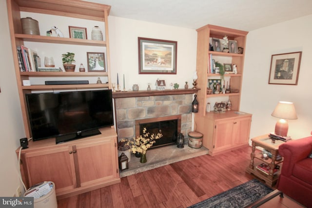 living area with wood finished floors and a fireplace