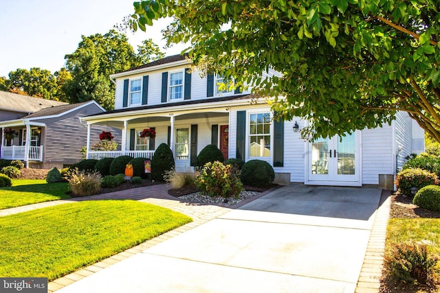 view of front of property with a porch, french doors, and a front yard