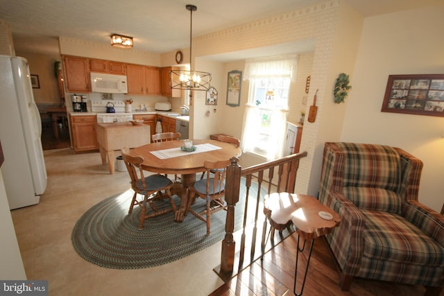 dining area featuring light wood-type flooring and a chandelier