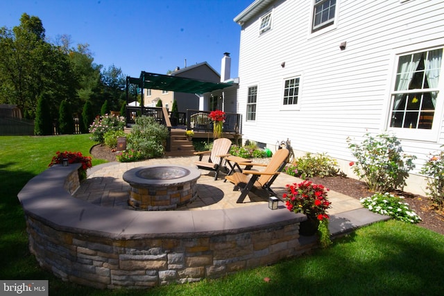 view of patio with a fire pit and a deck