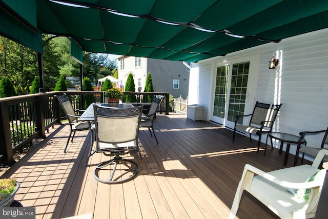 wooden terrace with outdoor dining area