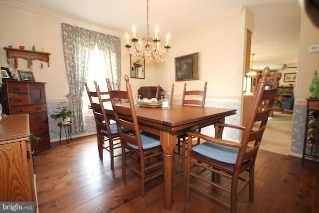 dining room with crown molding, an inviting chandelier, and dark wood-style flooring