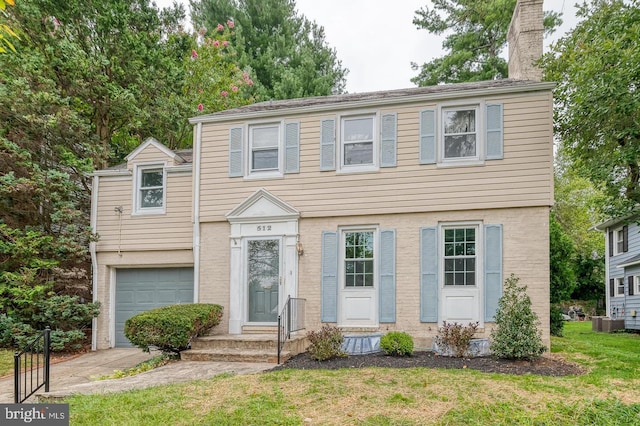 view of front of house with a front yard, an attached garage, central AC, and a chimney