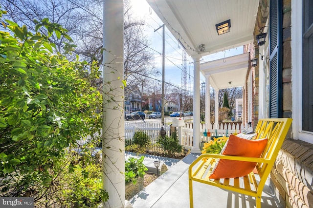 view of patio / terrace with fence and covered porch