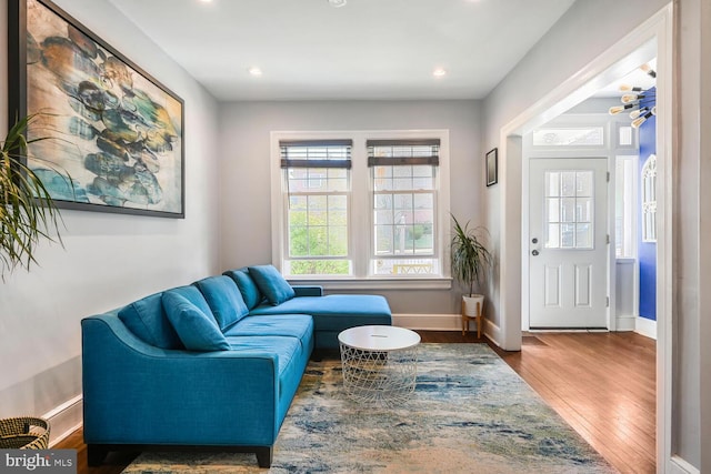 living area with recessed lighting, wood finished floors, and baseboards