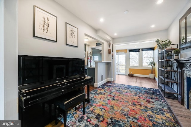 sitting room with visible vents, baseboards, recessed lighting, a fireplace, and wood finished floors