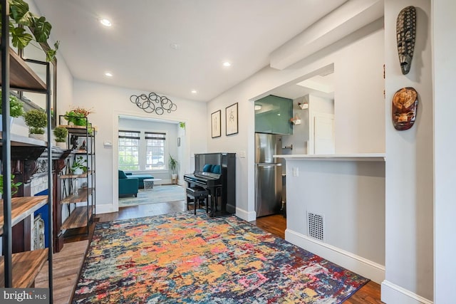 interior space featuring recessed lighting, visible vents, baseboards, and wood finished floors