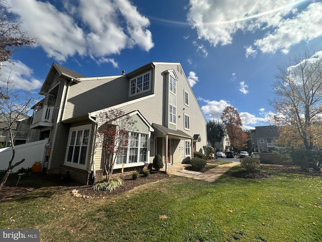 view of home's exterior with a lawn and fence