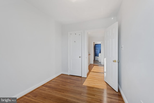 interior space featuring baseboards and wood finished floors