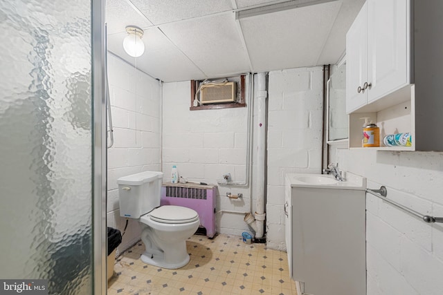 full bathroom with tile patterned floors, toilet, a wall mounted AC, radiator, and vanity