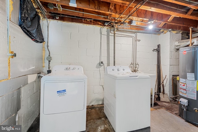 clothes washing area with washing machine and clothes dryer, laundry area, and water heater