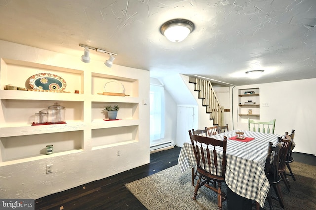 dining area featuring stairway, built in shelves, a baseboard radiator, dark wood finished floors, and a textured ceiling