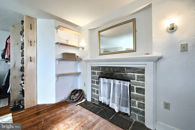 interior space featuring a stone fireplace and hardwood / wood-style floors