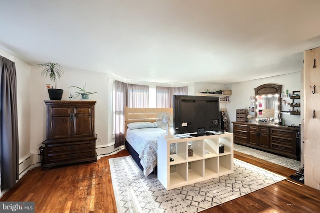 bedroom featuring wood-type flooring and a baseboard radiator