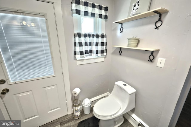 bathroom with toilet and wood finished floors