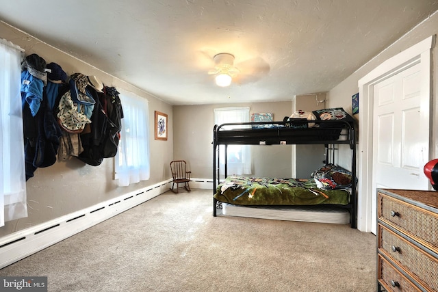 bedroom with a baseboard radiator and carpet floors