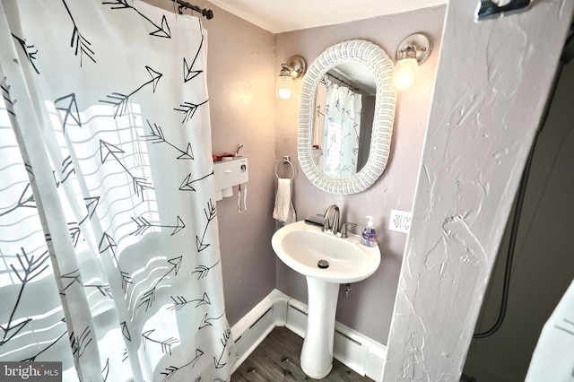 bathroom featuring baseboards and wood finished floors