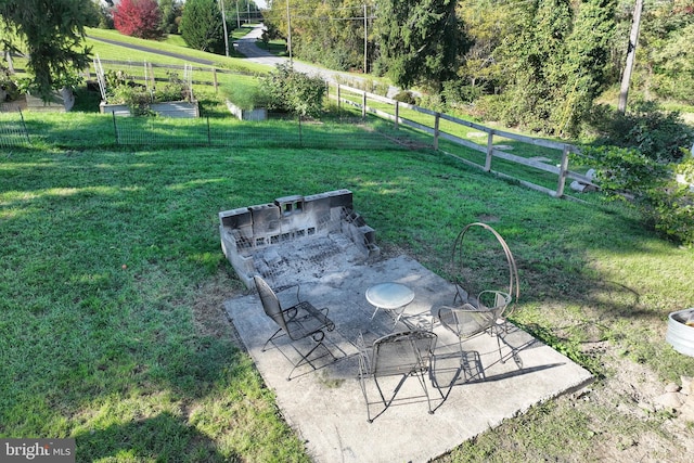 view of yard with a patio area, a rural view, and fence