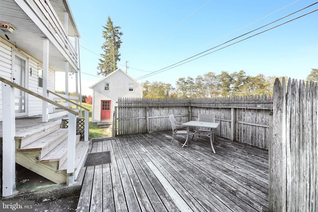 wooden terrace featuring outdoor dining area and fence