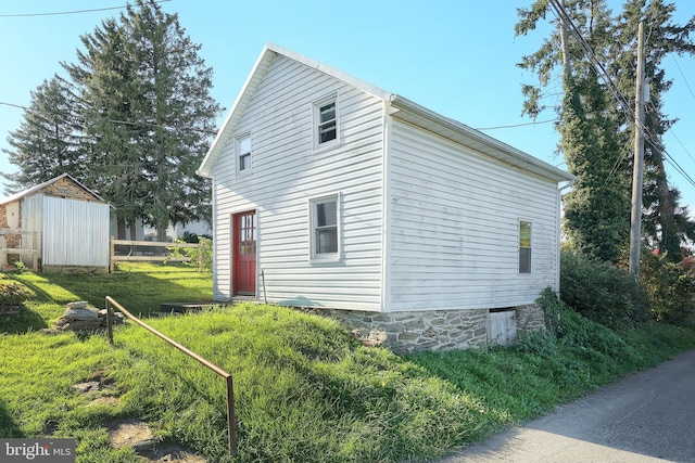 view of home's exterior featuring an outbuilding