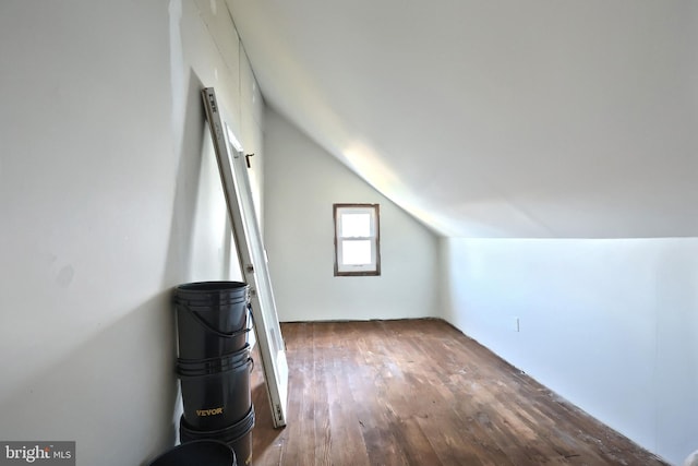 bonus room featuring wood finished floors and vaulted ceiling