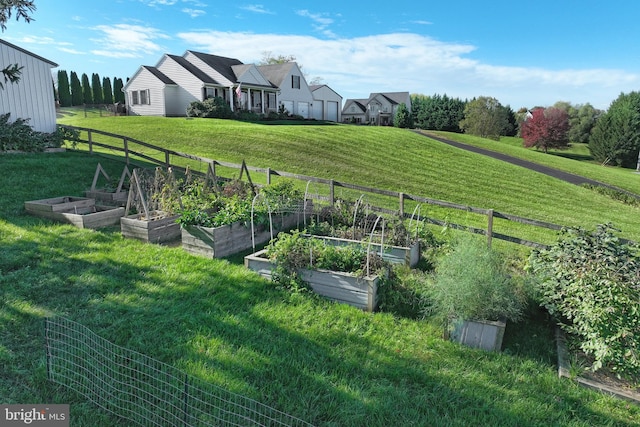 view of yard with a rural view, a vegetable garden, and fence