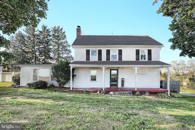 view of front of property featuring a chimney and a front yard