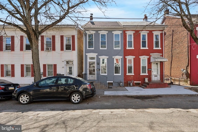 townhome / multi-family property featuring a chimney