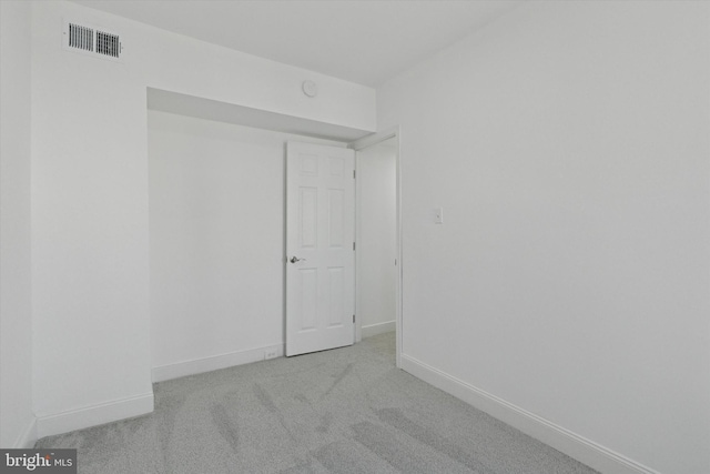 unfurnished room with baseboards, visible vents, and carpet floors