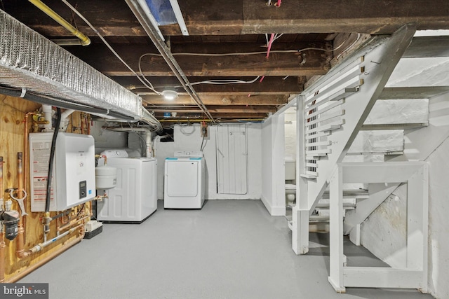 unfinished basement featuring stairs, independent washer and dryer, and tankless water heater