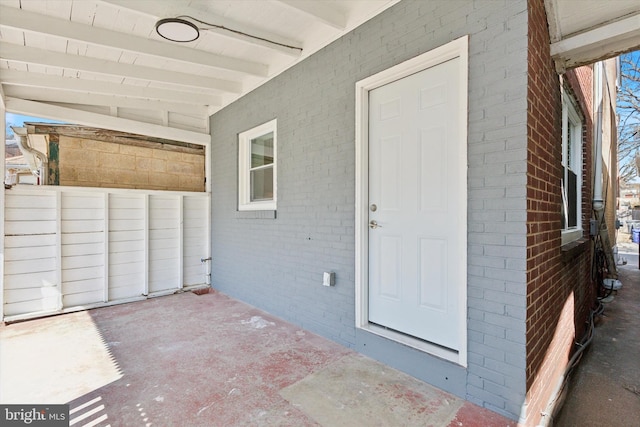 view of exterior entry with brick siding