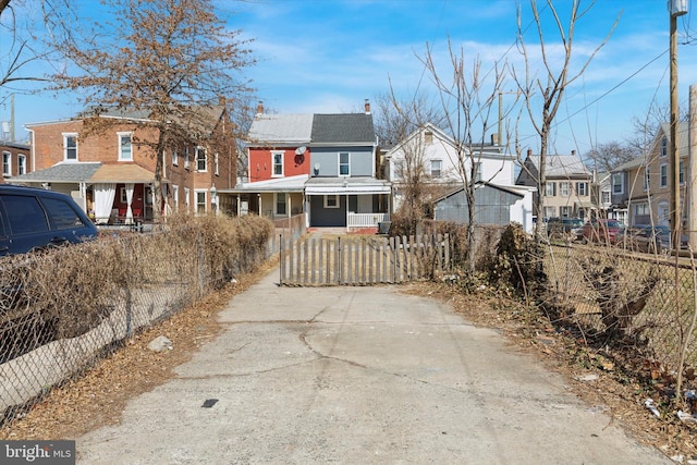 exterior space featuring a fenced front yard, a residential view, and a chimney