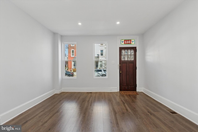 entryway featuring dark wood-type flooring, recessed lighting, and baseboards