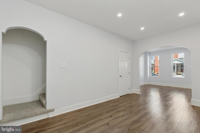 unfurnished room featuring recessed lighting, baseboards, and dark wood-style flooring