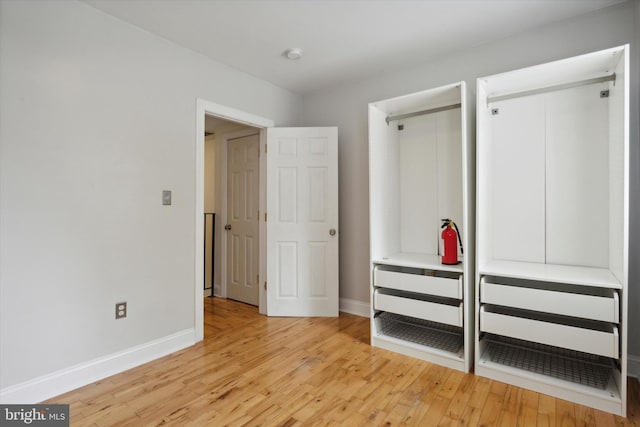 unfurnished bedroom featuring baseboards and light wood-style floors